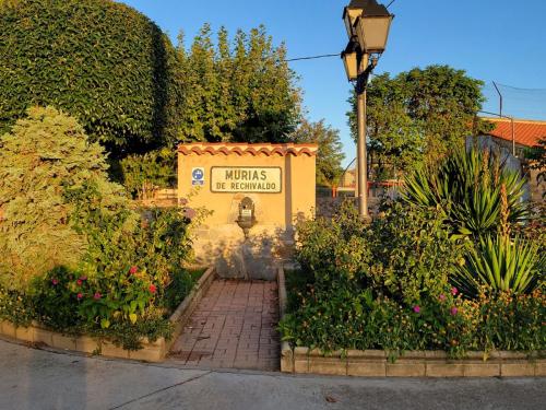 Beautifully adorned fountain in a small garden as we enter Murias de Rechivaldo