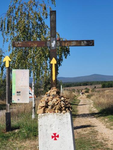 A small iron cross on a way marker