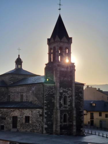 Rising sun shining through the bell tower.