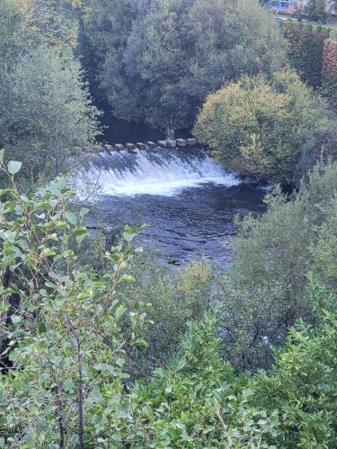 River overflowing the dam.