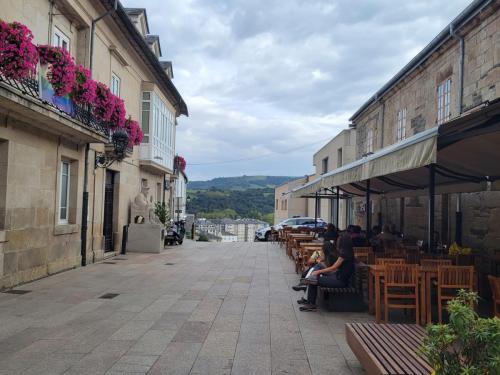 Typical street scene with flowers at the windows and Cafe tables.