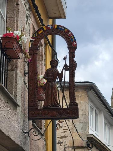 One of several carved signs indicating a hostel or shop.