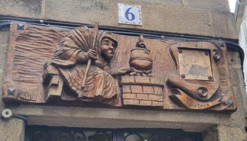 Carved wooden sign above a wine shop