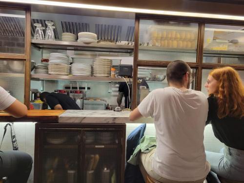 Bar eating in front of the glassed kitchen where the cooks, owner were singing along with the piped American rock music